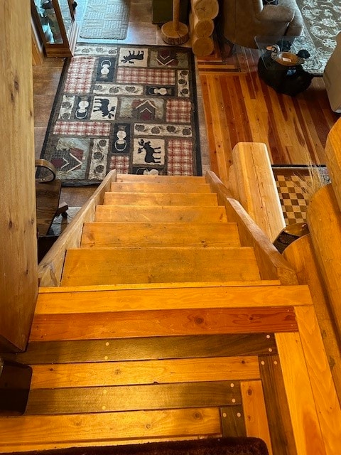 stairway with hardwood / wood-style flooring