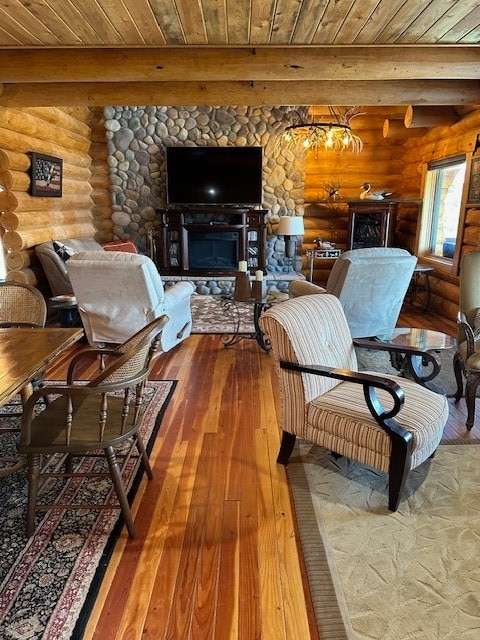 living room with hardwood / wood-style floors, beam ceiling, wooden ceiling, and rustic walls