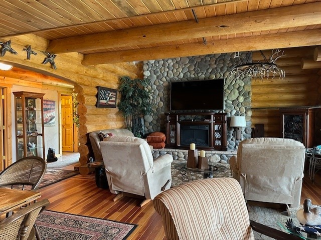 living room featuring wood ceiling, wood-type flooring, beamed ceiling, and a fireplace