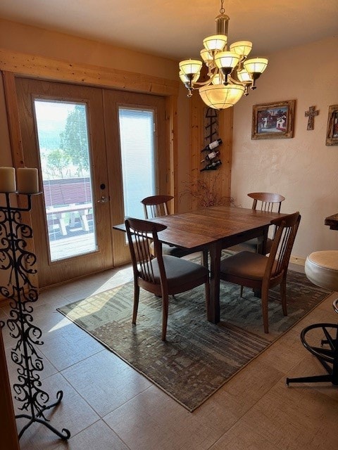 tiled dining room with french doors and a notable chandelier