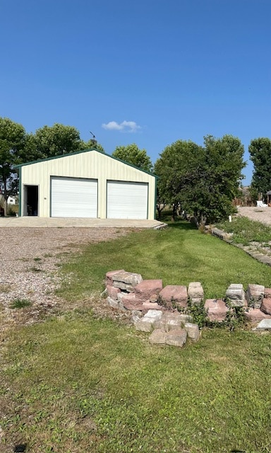 garage featuring a lawn