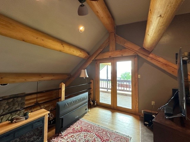 bonus room featuring hardwood / wood-style flooring and lofted ceiling with beams