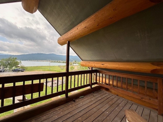 wooden terrace featuring a yard and a water and mountain view