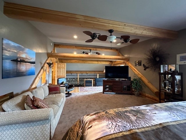 living room featuring beam ceiling, carpet, and ceiling fan