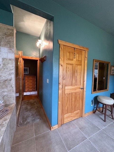 hall with tile patterned flooring