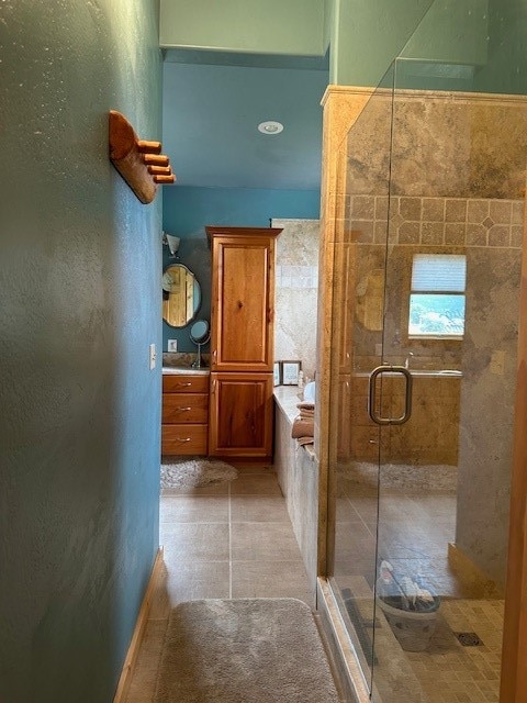 bathroom featuring tile walls, vanity, shower with separate bathtub, and tile patterned flooring