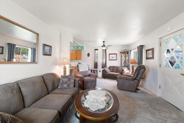 living room featuring ceiling fan, light carpet, and a wealth of natural light