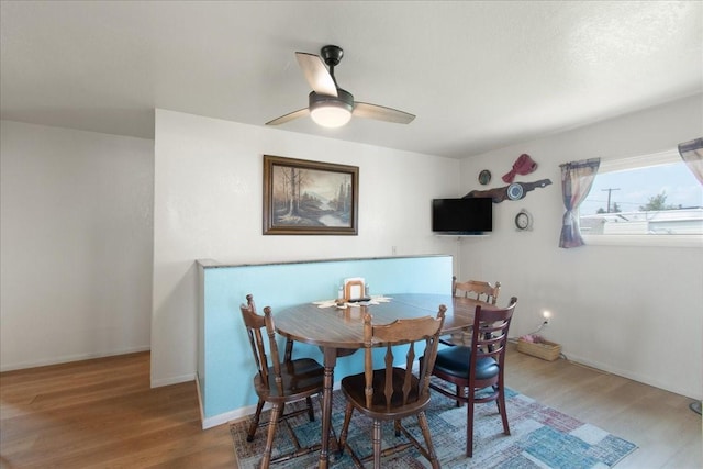 dining space featuring ceiling fan and hardwood / wood-style floors