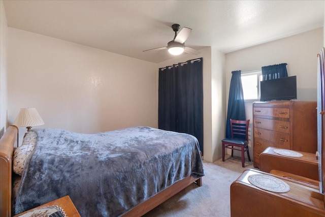 bedroom featuring light colored carpet and ceiling fan