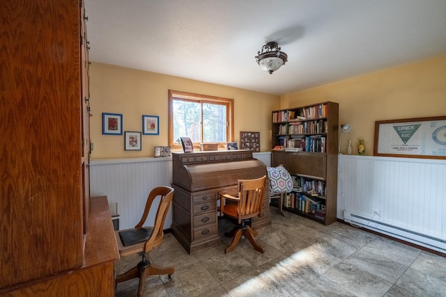 home office with a wainscoted wall and baseboard heating