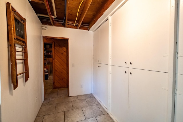 corridor featuring light tile patterned floors