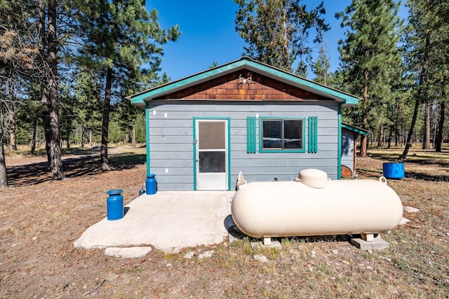 back of property with an outdoor structure