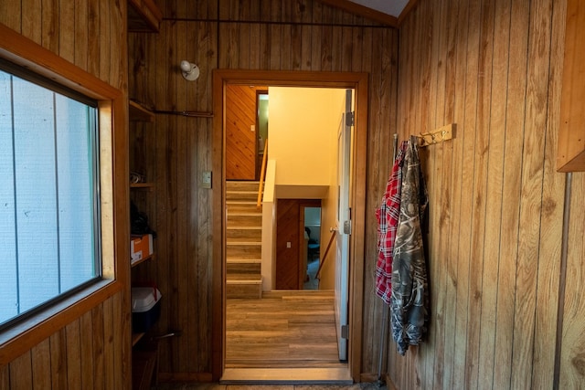 corridor with wood walls and stairway