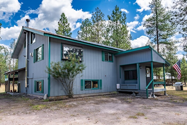 exterior space featuring a porch and metal roof