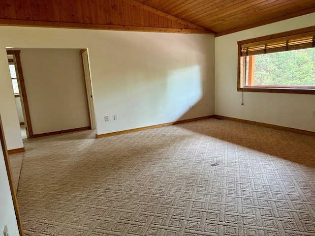 carpeted spare room featuring lofted ceiling and wooden ceiling