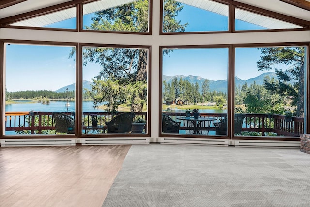 unfurnished sunroom with lofted ceiling with beams and a water and mountain view