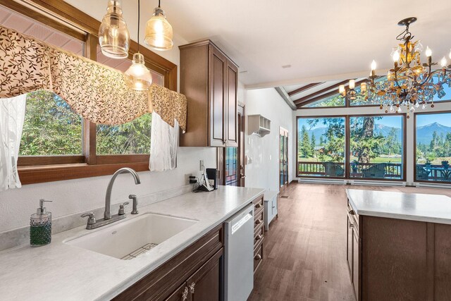 kitchen featuring a chandelier, dark hardwood / wood-style flooring, white appliances, sink, and a center island