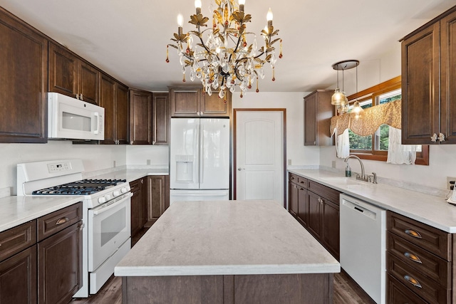 548 W Village Dr, Bigfork, MT 59911 - kitchen featuring white appliances, a center island, dark brown cabinets, light countertops, and a chandelier