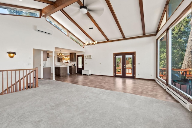 548 W Village Dr, Bigfork, MT 59911 - unfurnished living room featuring a chandelier, high vaulted ceiling, carpet flooring, a wall unit AC, and beam ceiling
