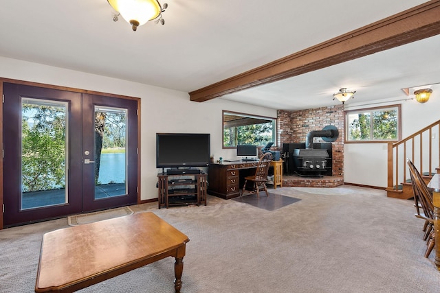 548 W Village Dr, Bigfork, MT 59911 - living area with healthy amount of natural light, light carpet, stairs, french doors, and beam ceiling