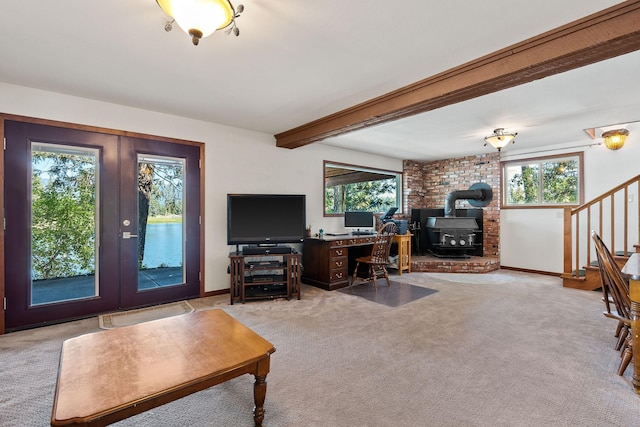 living room featuring light carpet, stairs, beam ceiling, and french doors