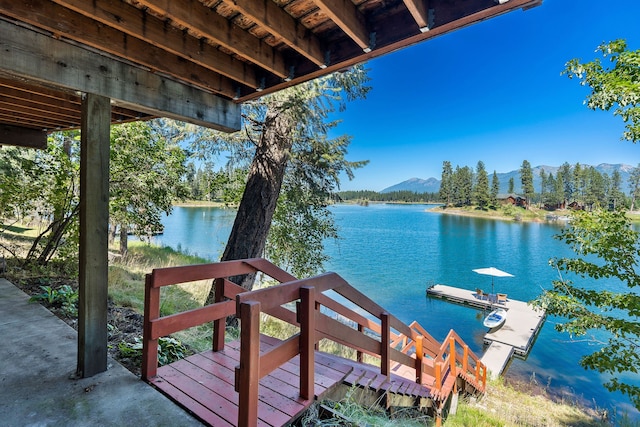 view of dock featuring a water and mountain view