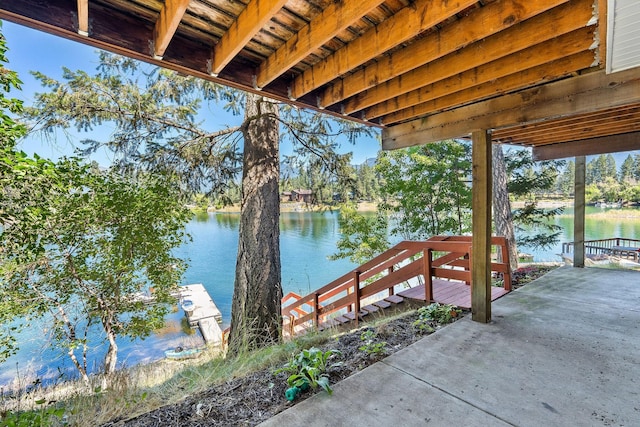 dock area featuring a water view and a patio