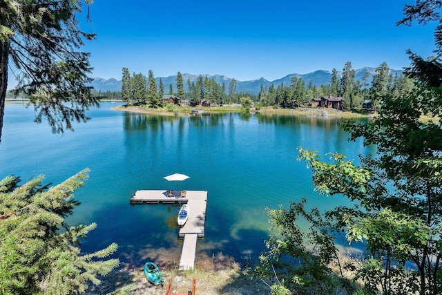 property view of water with a mountain view and a floating dock