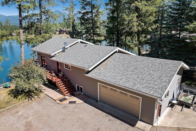 birds eye view of property featuring a water and mountain view