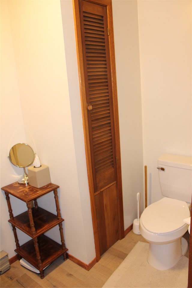 bathroom with toilet and hardwood / wood-style floors