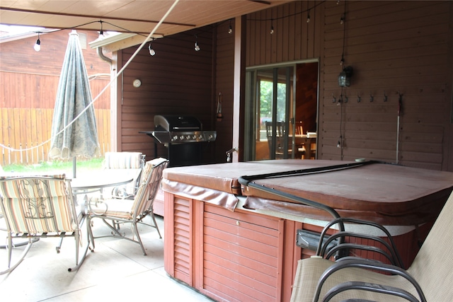 view of patio with area for grilling and a hot tub