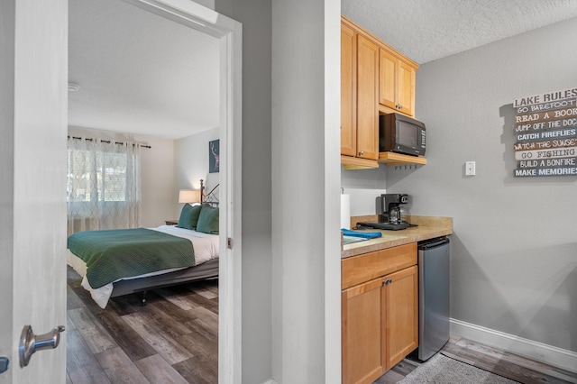 interior space with black microwave, baseboards, and wood finished floors