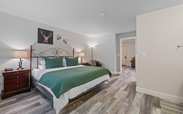 bedroom with wood finished floors and baseboards