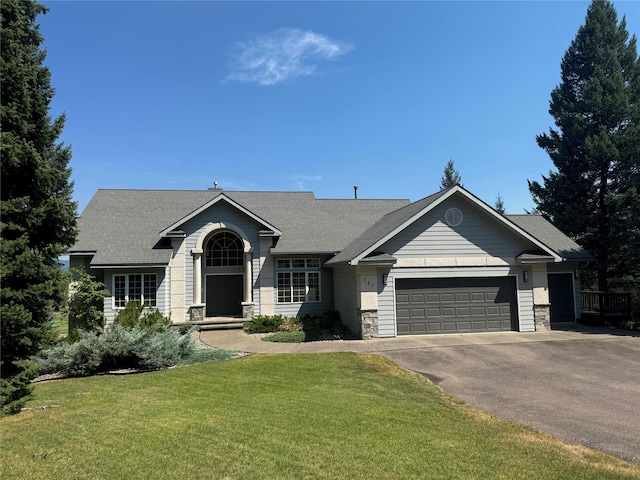 view of front of home featuring a garage and a front yard