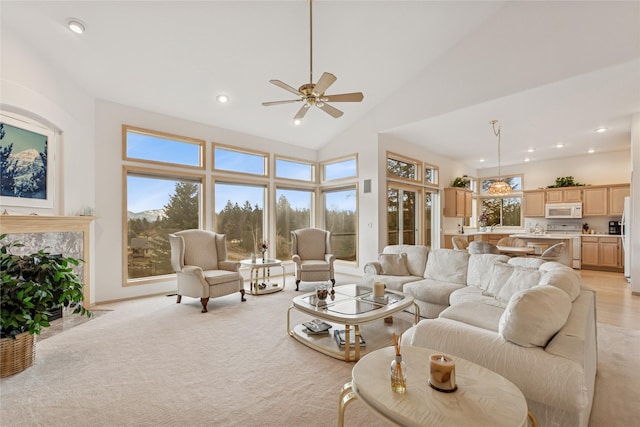 living area featuring high vaulted ceiling, recessed lighting, a ceiling fan, and light carpet