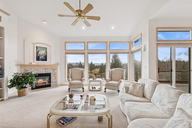 carpeted living area featuring a ceiling fan, recessed lighting, and a premium fireplace