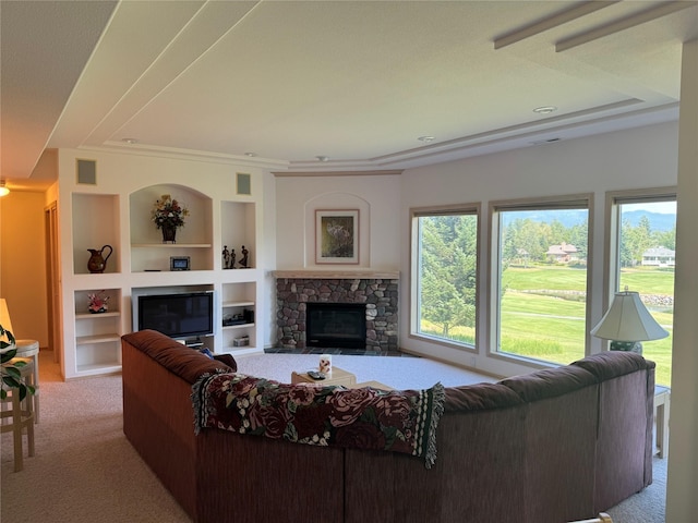 living room with built in features, a fireplace, and light carpet