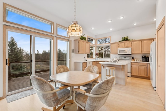 dining room with light wood-type flooring and recessed lighting