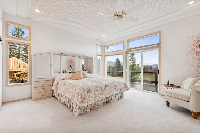 bedroom featuring multiple windows, a high ceiling, access to outside, and light colored carpet