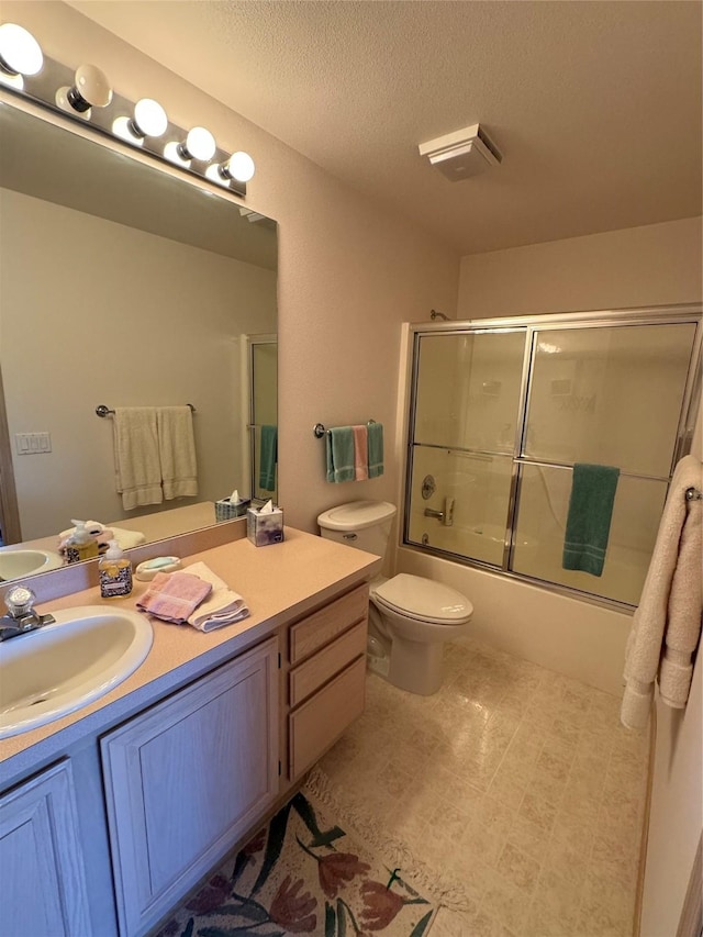 full bathroom featuring vanity, a textured ceiling, enclosed tub / shower combo, and toilet