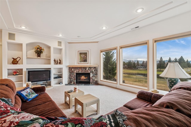carpeted living area featuring visible vents, a fireplace, recessed lighting, and built in shelves