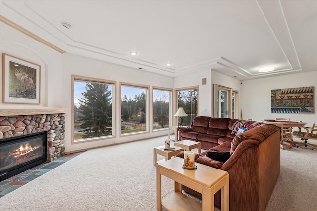carpeted living room with a stone fireplace and recessed lighting