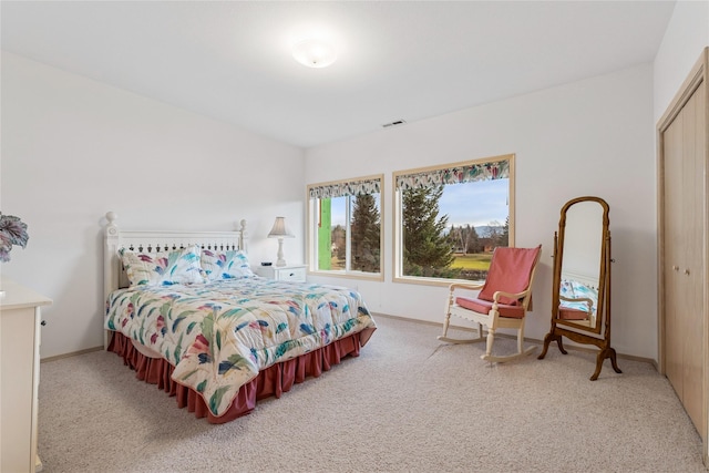 bedroom featuring baseboards, visible vents, a closet, and carpet flooring