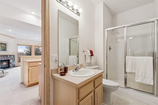 full bath with toilet, vanity, a fireplace, and a shower stall