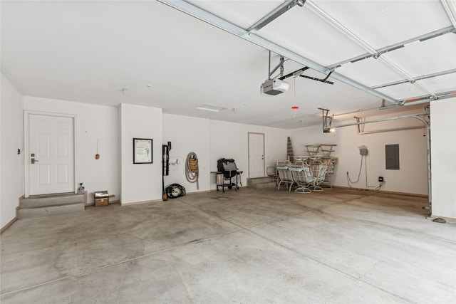 garage with electric panel and a garage door opener