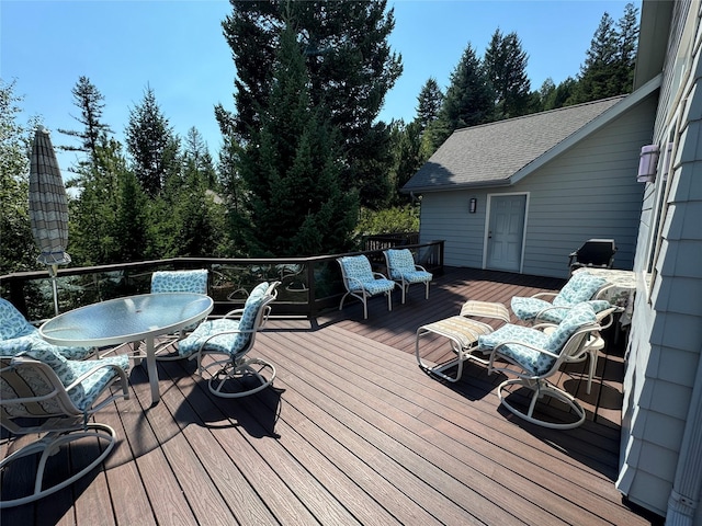 wooden terrace featuring outdoor dining area