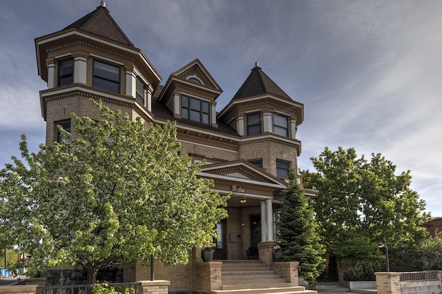 victorian home with brick siding