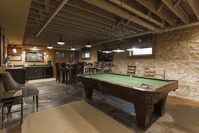 playroom featuring indoor wet bar, a sink, unfinished concrete flooring, and billiards