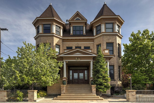 view of front facade with french doors and brick siding