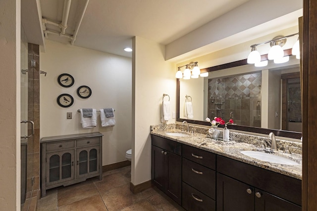 full bathroom with a shower stall, baseboards, and a sink